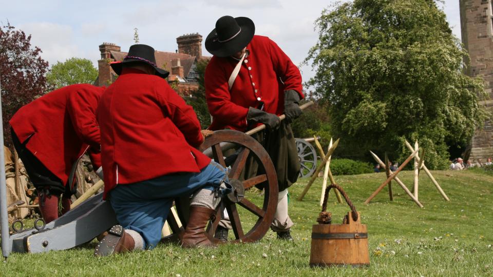 Civil War re-enactment fighters loading a cannon.