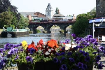 Newark bridge with a boat sailing on the river