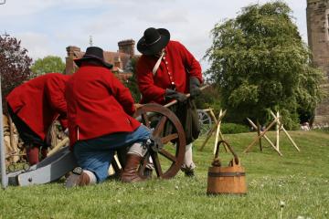 Civil War re-enactment fighters loading a cannon.